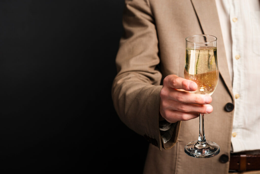 close-up-of-man-holding-glass-of-champagne-with-copy-space